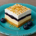 Fully prepared no-bake lemon blueberry dessert with creamy lemon filling, blueberry topping, and whipped topping, presented in a 13x9-inch dish.