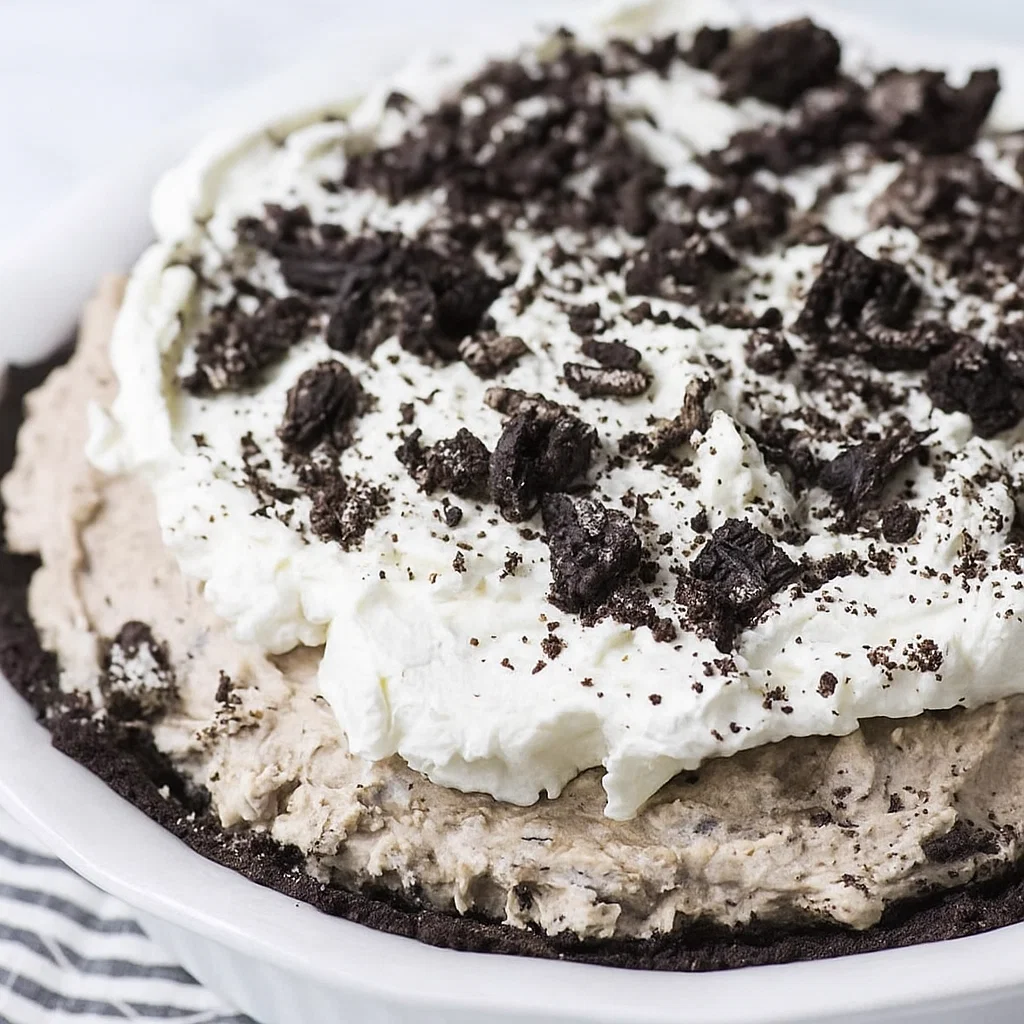 Oreo pudding pie Oreo Pudding Pie, topped with whipped cream and crushed Oreos, ready to serve