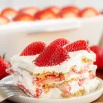 Finished no-bake strawberry icebox cake topped with fresh strawberries.