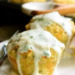 Close-up of Garlic Parmesan Chicken Meatloaves baked in muffin tin with melted cheese