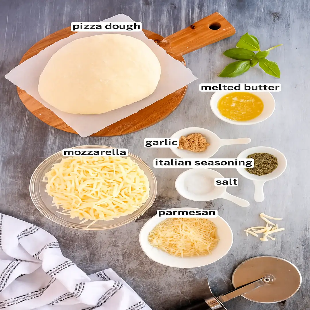 Homemade Cheesy Breadsticks Ingredients for homemade cheesy breadsticks on a rustic countertop