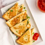 Spinach and feta quesadillas served hot with tzatziki and herbs